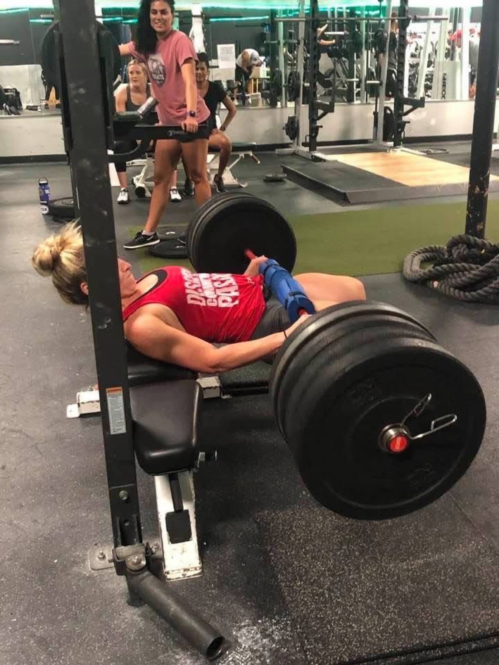 Tricia Martin performing a loaded barbell hip thrust during a strength training session